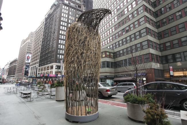 Oversize sculpture of bird of prey made from branches